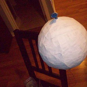 paint the paper mache with white acryllic paint