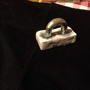 One of the chain attachments, there are two magnets in the casting that allow the chain to disconnect if pulled too hard.