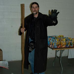 Harry Dresden WIP.

Canvas duster, leather glove, shield bracelet, staff, pentacle, and Bob the skull. Wearing jeans, silk shirt, and hiking boots.