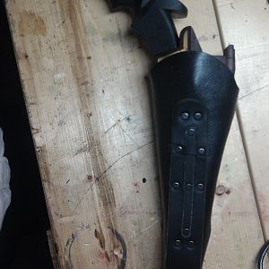 Black disruptor holster.  There is a lace to tie it to the leg, and hooks for a chain baldric.  The house of Martok symbol was added after the custome