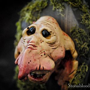 A plaster-cast "Goblin Minion" head on stained Pine and dired moss.