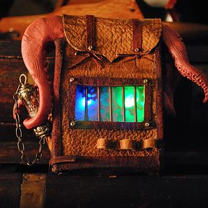 A doll-sized deer-skin "Traveler's Bag" made for a steampunk doll convention. Complete with inner LED lighting and sculpted tentacles.