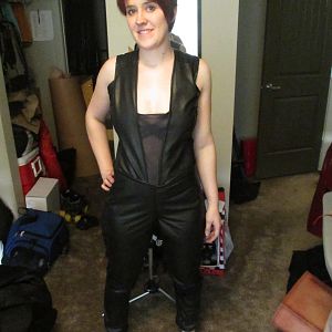 Full body suit, made from leather, mesh, and elastics. A zipper in the back allows it to be put on.