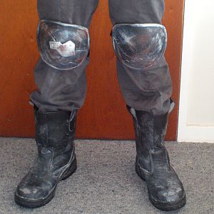 Craft foam kneepads and weathered steel-cap work boots.