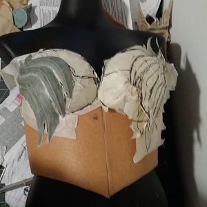sculpting the wing design on the breastplate
