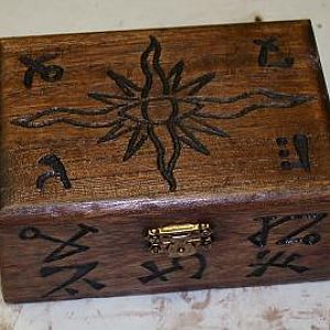 A prop carved wooden box with Lovecraftian sigils. Contained a bottle of mysterious green liquid.  (sold)