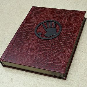 Commissioned recover of Pathfinder rpg rulebook, with custom resin sigil. (sold)