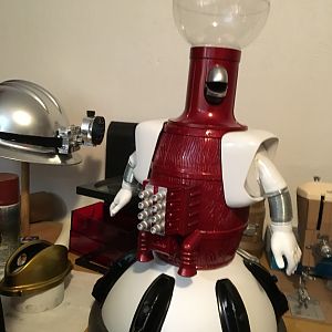 Tom servo, the crimson pig.
Real Parts:
"Executive snack dispenser" with extra lid
Stanley flashlight shoulder cowls
Arms from  a Cmore Bunz doll