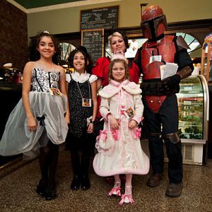 our family at a convention Lolitas and a Mando dresses sewn by me and mandolorian armour made by my husband Chad