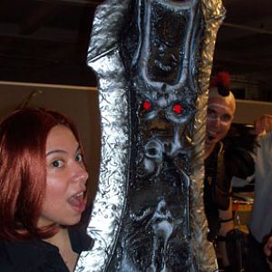 woman holding chaoseater showing glowing eyes effect.