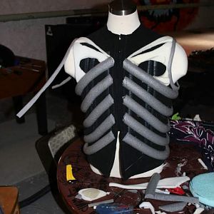 Grey foam tubes cut in half make the ribs. Thin sheet foam makes the pectoral details. I wanted the costume to be light-weight and flexible.